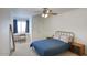 Cozy bedroom with blue bedding, a side table and a desk with a chair at 1750 E Mallory St, Mesa, AZ 85203