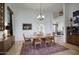 Spacious dining room with wood floors, a decorative rug and large table perfect for entertaining at 1750 E Mallory St, Mesa, AZ 85203