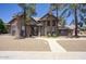 Traditional brick home with well-kept landscaping, a cozy entrance and an attached three-car garage at 1750 E Mallory St, Mesa, AZ 85203