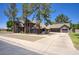 Charming single-Gathering home features a neutral color palette, spacious driveway, and mature trees in the front yard at 1750 E Mallory St, Mesa, AZ 85203
