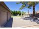 Home's exterior featuring a garage, a putting green, and a sparkling pool at 1750 E Mallory St, Mesa, AZ 85203