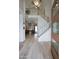 Inviting foyer with wood floors, a staircase with white railing, and views into the adjacent living spaces at 1750 E Mallory St, Mesa, AZ 85203