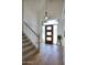 Inviting foyer features hardwood floors and a staircase and a light-filled entrance with modern accents at 1750 E Mallory St, Mesa, AZ 85203