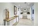 Bright hallway with desk area, wood-look floors, and elegant decorative touches at 1750 E Mallory St, Mesa, AZ 85203