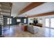 Spacious living room with exposed beams, hardwood floors, and access to the backyard at 1750 E Mallory St, Mesa, AZ 85203