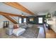 Open-concept living area with wood beams, comfortable seating, and abundant natural light at 1750 E Mallory St, Mesa, AZ 85203