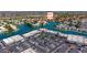 High-angle view of condo community with shopping center, parking, and lakefront properties amid a lush, green landscape at 1825 W Ray Rd # 1119, Chandler, AZ 85224