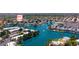 Aerial view showcasing waterfront condo community with scenic lake, lush landscaping, and nearby shopping at 1825 W Ray Rd # 1119, Chandler, AZ 85224