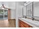 Bathroom with double sinks, granite countertops, wooden cabinets, and access to the bedroom at 1825 W Ray Rd # 1119, Chandler, AZ 85224