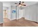 Bedroom with wood-look flooring, a ceiling fan, and ensuite bathroom with a glass-enclosed shower at 1825 W Ray Rd # 1119, Chandler, AZ 85224
