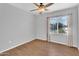 Bright bedroom with wood-look floors and a window overlooking a tranquil neighborhood at 1825 W Ray Rd # 1119, Chandler, AZ 85224