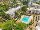 Aerial view of community pool and apartment buildings with lush greenery, fencing, and well-maintained landscaping at 1825 W Ray Rd # 1119, Chandler, AZ 85224