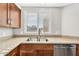Close-up of kitchen sink area with granite countertops, stainless steel sink, and faucet under a window at 1825 W Ray Rd # 1119, Chandler, AZ 85224