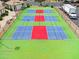 Aerial view showcasing three outdoor pickleball courts, each a vibrant combination of red and blue at 1825 W Ray Rd # 1119, Chandler, AZ 85224