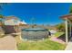 Enclosed backyard featuring a round above-ground pool, stone walls, and green lawn at 1950 E Kings Ave, Phoenix, AZ 85022