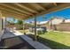 View of a covered patio, lawn, above-ground pool, and block wall in a private backyard at 1950 E Kings Ave, Phoenix, AZ 85022