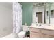 Clean bathroom with a shower-tub combo, decorative shower curtain, and ample counter space at 1950 E Kings Ave, Phoenix, AZ 85022