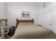Cozy bedroom features a wooden bed frame, soft lighting, and a neutral color palette at 1950 E Kings Ave, Phoenix, AZ 85022