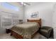 Cozy bedroom with a comfy wood bed frame, neutral carpet, a picture on the wall and a clerestory window at 1950 E Kings Ave, Phoenix, AZ 85022