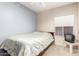Standard bedroom features a ceiling fan, neutral carpet, and a patterned bedspread at 1950 E Kings Ave, Phoenix, AZ 85022