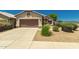 Charming single-story home with a well-maintained front yard, desert landscaping and brown garage door at 1950 E Kings Ave, Phoenix, AZ 85022