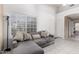 Bright living room featuring tile floors, a comfortable gray couch, and a large window with sunlight at 1950 E Kings Ave, Phoenix, AZ 85022