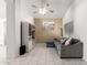 Open-concept living room with neutral tile, white entertainment center, and a comfortable gray sectional couch at 1950 E Kings Ave, Phoenix, AZ 85022