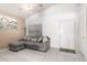 Inviting living room featuring a gray couch, tile floors, neutral decor, and vaulted ceilings at 1950 E Kings Ave, Phoenix, AZ 85022