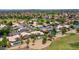 Aerial view of community featuring lush green golf course, mature trees, and mountain views at 19506 N 73Rd Ave, Glendale, AZ 85308