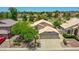 Aerial view of community featuring lush green golf course, mature trees, and desert landscaping at 19506 N 73Rd Ave, Glendale, AZ 85308