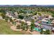 Aerial view of community featuring lush green golf course, mature trees, and mountain views at 19506 N 73Rd Ave, Glendale, AZ 85308