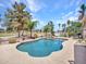 Inviting backyard featuring a spacious pool, spa, and well-manicured landscaping, offering privacy and tranquility at 19506 N 73Rd Ave, Glendale, AZ 85308