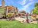Spacious backyard features an inground pool, lush artificial grass, and mature trees, perfect for outdoor entertaining at 19506 N 73Rd Ave, Glendale, AZ 85308
