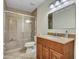 Updated bathroom features tile shower and wood vanity with granite countertop at 19506 N 73Rd Ave, Glendale, AZ 85308