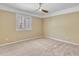 Neutral bedroom featuring carpeted floors, a window with shutters, and ceiling fan at 19506 N 73Rd Ave, Glendale, AZ 85308