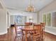Bright dining room with wood furniture, chandelier, and view into adjacent living room at 19506 N 73Rd Ave, Glendale, AZ 85308