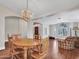 Dining room offers hardwood floors, wood table, chandelier, and views into adjoining living areas at 19506 N 73Rd Ave, Glendale, AZ 85308