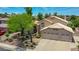 A lush landscape surrounds this attractive home, with a three car garage and light tile roof at 19506 N 73Rd Ave, Glendale, AZ 85308