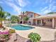 Expansive backyard featuring a pool and outdoor living space, complemented by lush landscaping and a two-story home at 19506 N 73Rd Ave, Glendale, AZ 85308