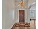 Elegant foyer featuring wood floors, a decorative chandelier, archways, and natural light filtering through sidelight windows at 19506 N 73Rd Ave, Glendale, AZ 85308