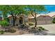 The appealing two-story home features a well-manicured yard, three-car garage, and charming curb appeal at 19506 N 73Rd Ave, Glendale, AZ 85308