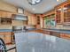 Bright kitchen featuring stainless steel appliances, wood cabinets, and spacious granite countertops at 19506 N 73Rd Ave, Glendale, AZ 85308