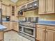 A chef's kitchen features a high-end stainless steel range, ample storage, and blue countertops at 19506 N 73Rd Ave, Glendale, AZ 85308