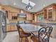Bright kitchen with island, stainless appliances, tile floors, and ample wood cabinets under skylight at 19506 N 73Rd Ave, Glendale, AZ 85308