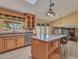 Bright kitchen with island, stainless appliances, tile floors, and ample wood cabinets at 19506 N 73Rd Ave, Glendale, AZ 85308