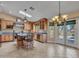 Large open kitchen boasts island with bar seating, skylight, and stainless steel appliances at 19506 N 73Rd Ave, Glendale, AZ 85308