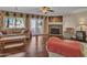 Cozy living room showcases a stone fireplace, hardwood floors, and access to the outdoor patio at 19506 N 73Rd Ave, Glendale, AZ 85308