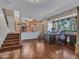 Spacious living room featuring hardwood floors, a large window, and a glimpse of the adjacent kitchen at 19506 N 73Rd Ave, Glendale, AZ 85308