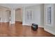 Open living area featuring hardwood floors, white trim, and bright, shuttered windows at 19506 N 73Rd Ave, Glendale, AZ 85308