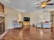 Bright living room featuring comfortable seating, a ceiling fan, and a fireplace for a relaxed atmosphere at 19506 N 73Rd Ave, Glendale, AZ 85308